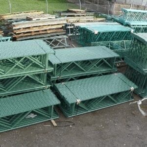 A lot of green cages sitting on top of each other.