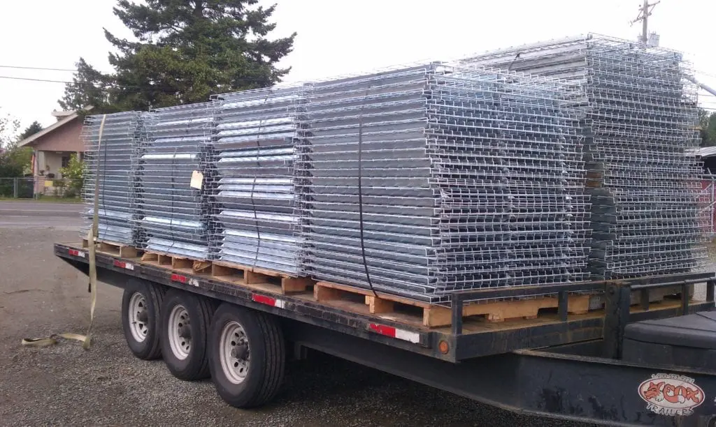 A trailer with stacks of metal frames on it.