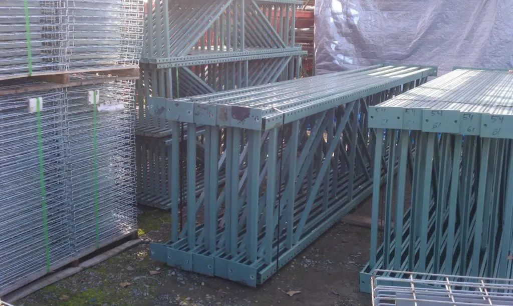 A group of metal cages sitting on top of concrete.