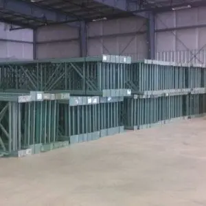 A warehouse with many metal crates stacked on top of each other.