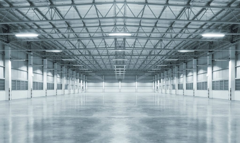 A large empty warehouse with lots of lights.